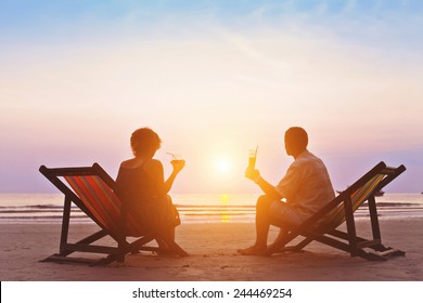 family enjoying romantic sunset on the beach