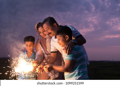 The family enjoying the sparkle fireworks as part of the celebration of a festival