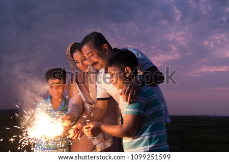 The family enjoying the sparkle fireworks as part of the celebration of a festival