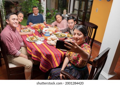 Family Enjoying A Tamale At A Dinner Party.