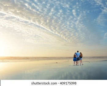 Family Enjoying Time Together On Beautiful Beach At Sunrise., Jacksonville, Florida, USA. 