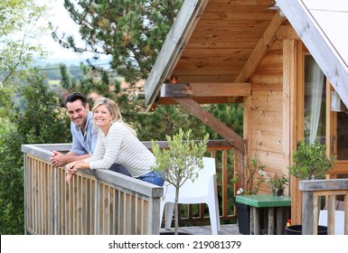 Family Enjoying Vacation In Log Cabin