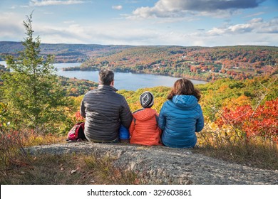 A Family Enjoying The Views After A Hike From A Beautiful Overlook In The Fall