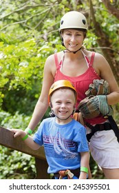 Family Enjoying A Zip Line Adventure On Vacation