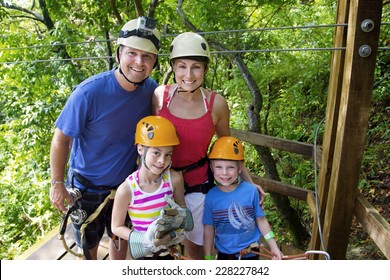 Family Enjoying A Zipline Adventure On Vacation