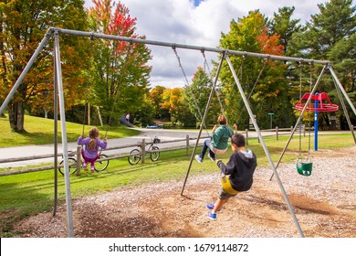 Family enjoys swinging at playground
