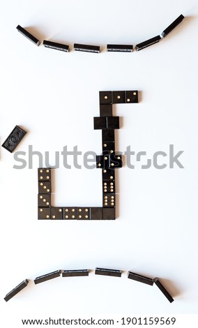 Family entertainment for a fun leisure game of dominoes. The bones are laid out on a white background
