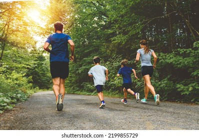 A Family exercising and jogging together at an outdoor park - Powered by Shutterstock