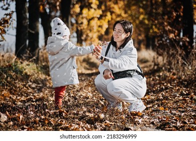 Family Fall Activities. Happy Family Single Mom And Toddler Baby Girl Playing Outdoors In Fall Park