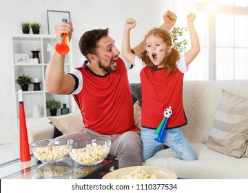 A family of fans watching a football match on TV at home
 - Powered by Shutterstock