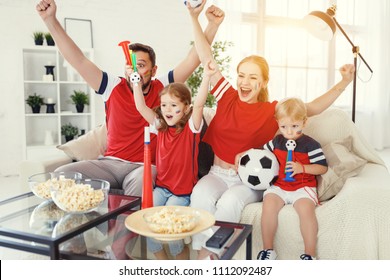 A family of fans watching a football match on TV at home
 - Powered by Shutterstock