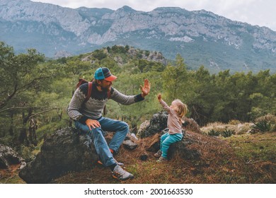 Family father and child daughter high five hands traveling in mountains hiking together summer vacation adventure lifestyle outdoor Lycian way in Turkey