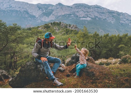 Family father and child daughter high five hands traveling in mountains hiking together summer vacation adventure lifestyle outdoor Lycian way in Turkey