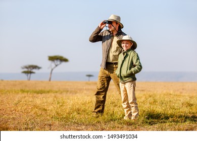 Family Of Father And Child On African Safari Vacation Enjoying Bush View