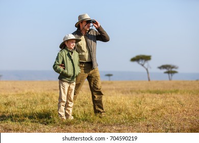 Family Of Father And Child On African Safari Vacation Enjoying Bush View