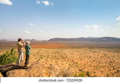 Family Of Father And Child On African Safari Vacation Enjoying View Over Samburu Kenya