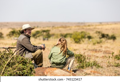 Family Of Father And Child On African Safari Vacation Enjoying Bush View