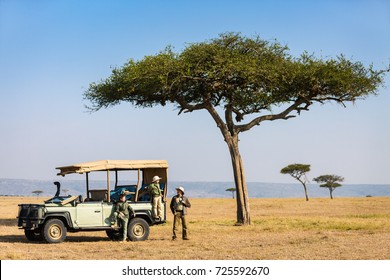 Family Of Father And Kids On African Safari Vacation Enjoying Morning Game Drive