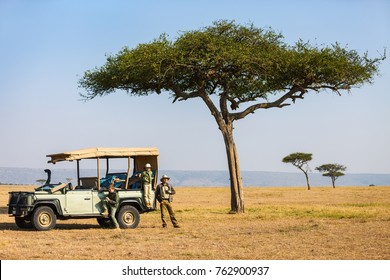 Family Of Father And Kids On African Safari Vacation Enjoying Morning Game Drive