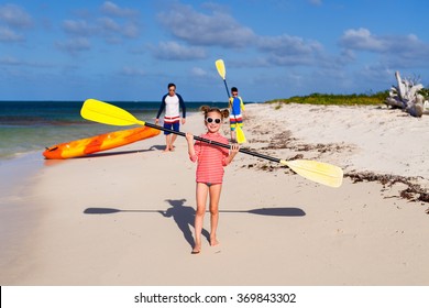 Family Father And Kids Pulling Colorful Kayaks After Paddling At Tropical Ocean Water During Summer Vacation