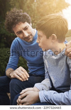 Family, father and son have conversation in backyard, bonding with love and care, communication and relationship. Man help by giving teen boy advice at home, outdoor together with trust and support