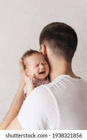 family, fatherhood and people concept - happy father holding little baby daughter at home
