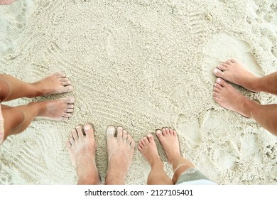 Family Feet On The Sand On The Beach In Holiday