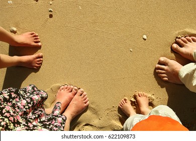 a Family feet on the sand on the beach - Powered by Shutterstock