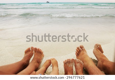 a Family feet on the sand on the beach