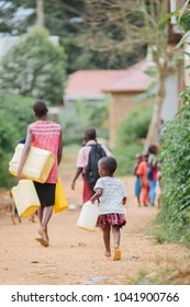 Family Fetching Water In Uganda Africa