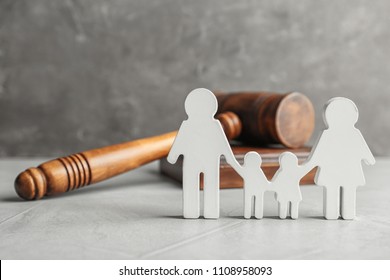 Family figure and gavel on table. Family law concept - Shutterstock ID 1108958093