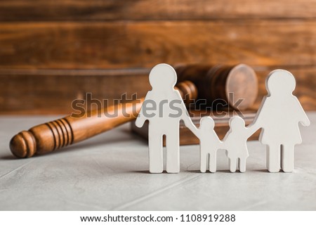 Family figure and gavel on table. Family law concept