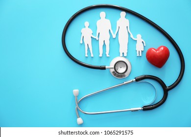 Family Figure, Red Heart And Stethoscope On Color Background. Health Care Concept