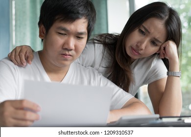 Family Financial Crisis. Stressed Young Asian Couple Looking At Issues Notification From Bank About Late Payment Home Loan Credit.