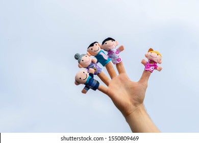 family finger puppet theater. child hand with finger puppets: son, daughter,mum, dad, granny, granddad. Kid playing fingers puppets. Family and generation concept. quarantine isolation home