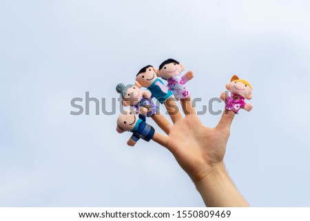 family finger puppet theater. child hand with finger puppets: son, daughter,mum, dad, granny, granddad. Kid playing fingers puppets. Family and generation concept. quarantine isolation home