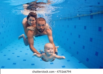 Family Fitness - Mother, Father, Baby Son Learn To Swim Together, Dive Underwater With Fun In Pool Active Parent Lifestyle, People Water Sport Activity And Physical Exercises, Children Swimming Lesson