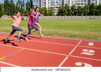 Family Fitness, Mother And Kids Running On Stadium Track, Exercise With Children  And Sport Healthy Lifestyle Concept
