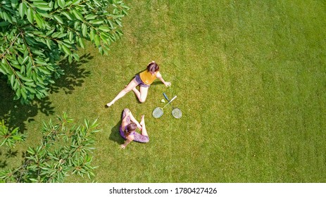 Family Fitness And Sport Outdoors, Active Mother And Daughter Teenager Playing Badminton In Park, Aerial Top View From Above
