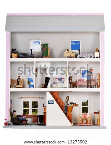 A family of five working and playing inside a furnished doll house.