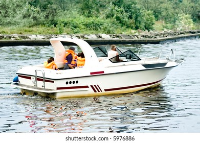 A family floating by motorboat, kids on the board