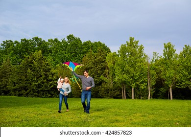 Family With Flying Kite In Park