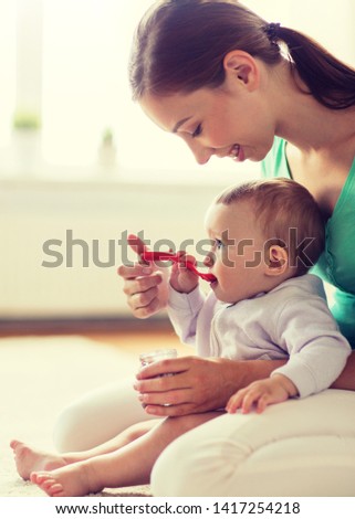 Similar – Mother with eating toddler.