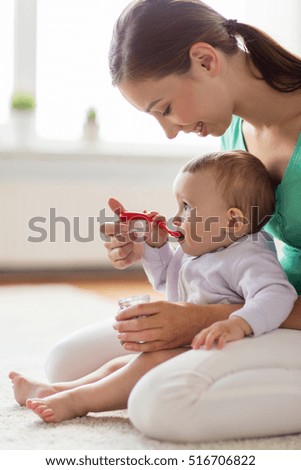 Similar – Mother feeding baby with baby bottle