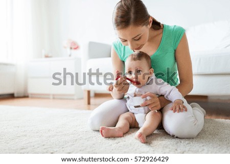 Similar – Mother feeding baby with baby bottle