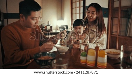 Family, food and dinner with girl, parents and Japanese with joy, meal and home with happiness. Mother, apartment and father with kid, noodles and bonding together with nutrition, smile and love