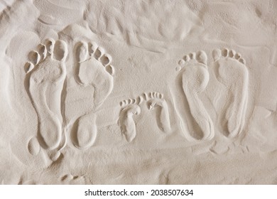 Family footprints on sandy beach, top view - Powered by Shutterstock