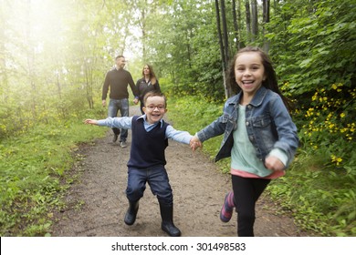 A Family In Forest On A Meadow