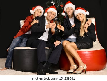 Family Of Four Celebrating Chrismas On Black Background