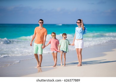 Young Family Four On Beach Vacation Stock Photo (Edit Now) 1676560351